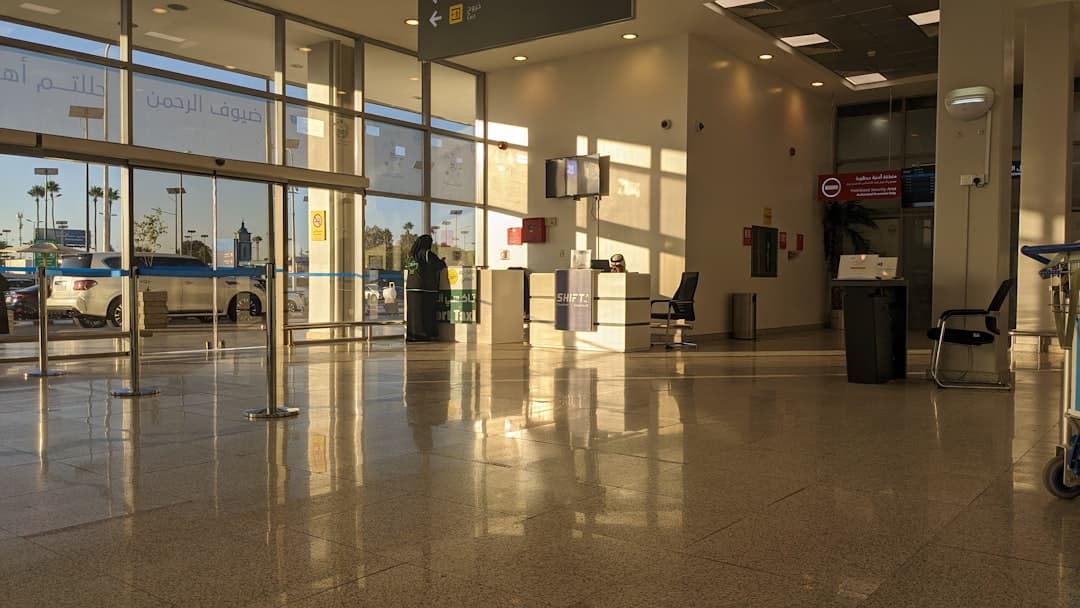 Modern airport terminal with large windows and sunlight reflections. — Photo by Yulaan on Unsplash