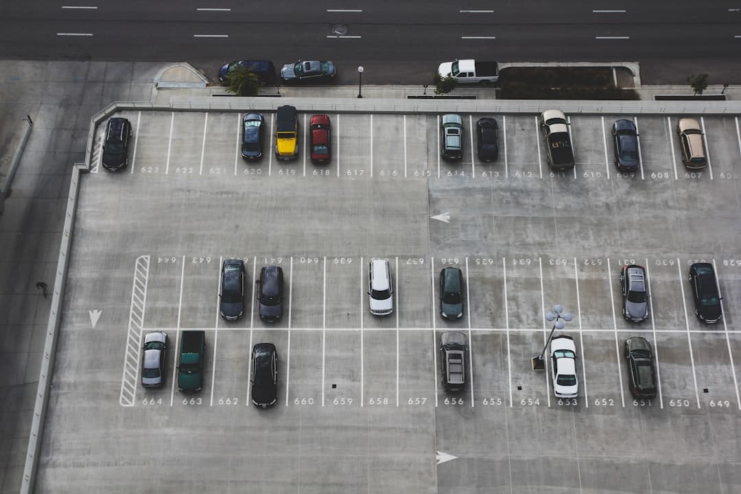 aerial view of cars parked on parking lot — Photo by John Matychuk on Unsplash
